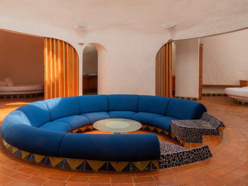 Sofá azul circular hundido en el salón de la Casa de la Estrella