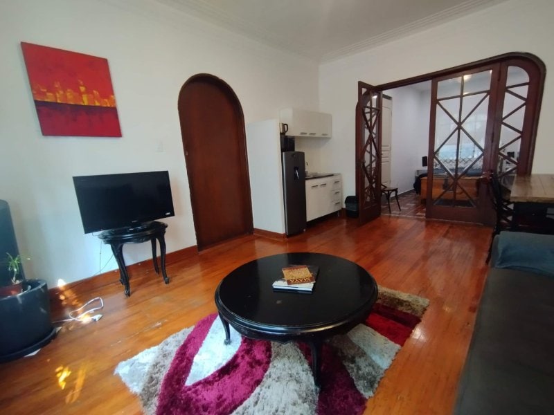 Sala de estar con pisos de madera y una entrada arqueada en la Suite con Desayuno Gratis de Camino Real en Anzures, Ciudad de México
