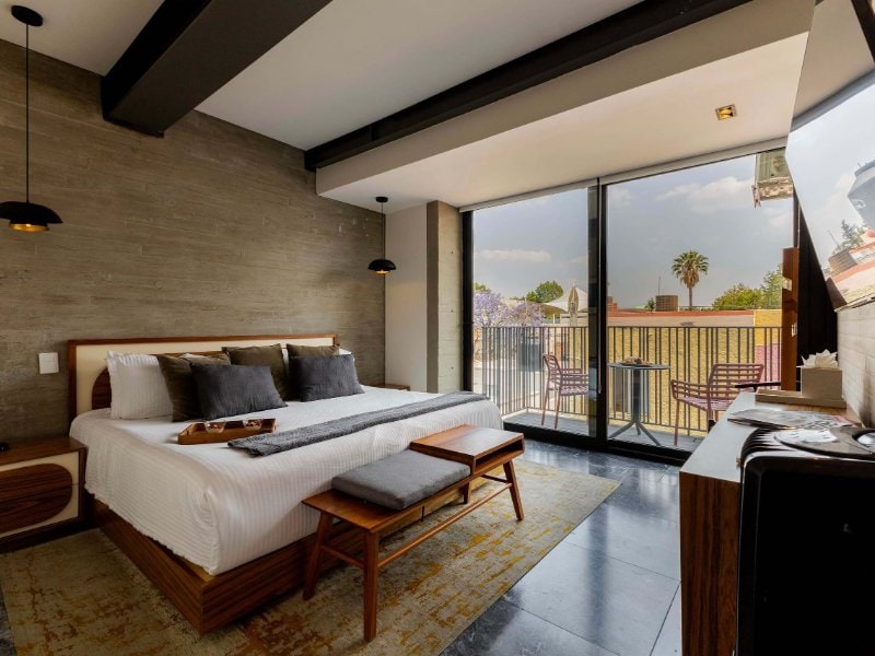 Dormitorio con cama king y puertas de balcón en el Apartamento Polanco de 3 dormitorios de Masaryk, Ciudad de México