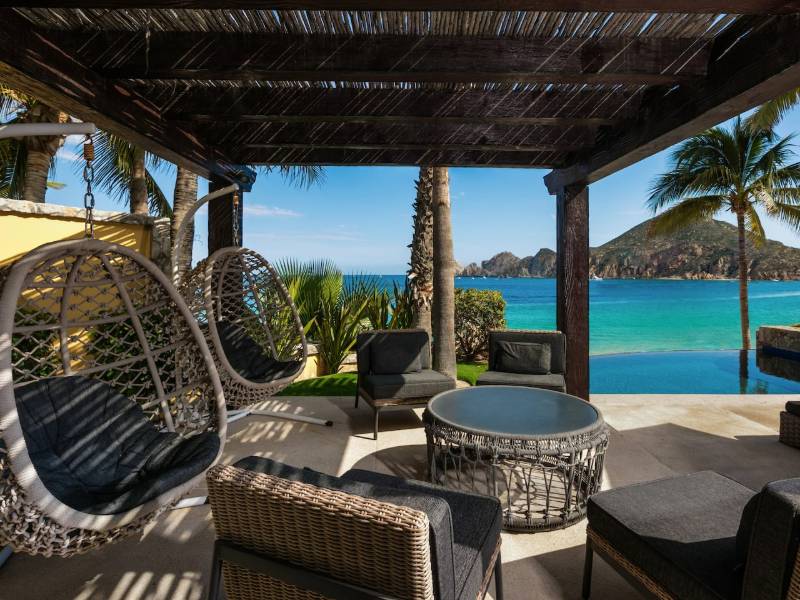 Terraza sombreada con sillas colgantes frente a la playa Médano en Villa 1, Hacienda Beach Club, Cabo San Lucas