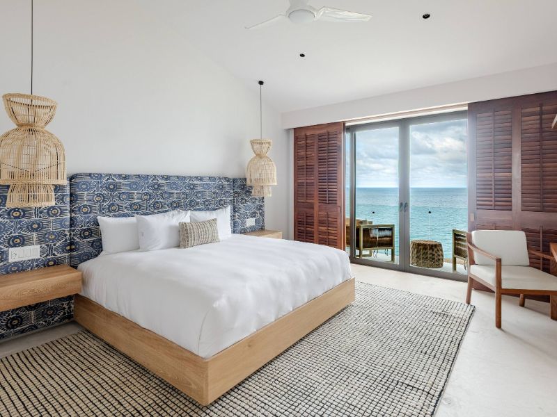 Dormitorio con vista al mar en la villa Casa Juntos en la ladera sobre la Bahía de Litibu